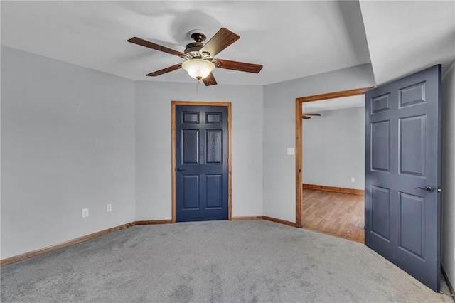 unfurnished bedroom featuring carpet floors, baseboards, and a ceiling fan