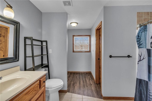 bathroom with visible vents, toilet, a shower with curtain, tile patterned floors, and vanity