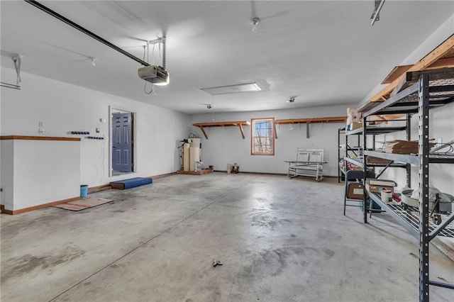 garage with water heater, baseboards, and a garage door opener