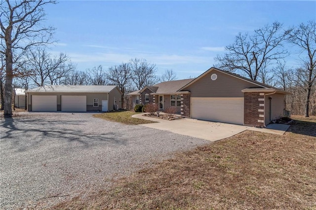 view of front facade with a garage, concrete driveway, and brick siding