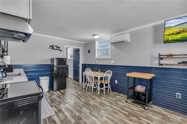 bar featuring freestanding refrigerator, wainscoting, a textured ceiling, and a wall mounted AC