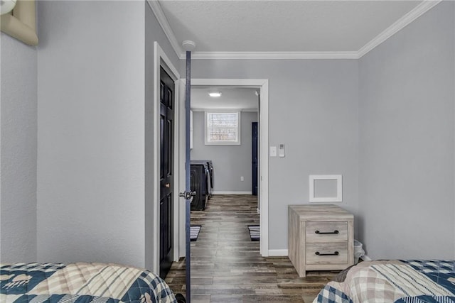 bedroom with ornamental molding, dark wood-type flooring, and baseboards