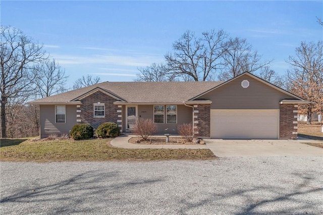 ranch-style home with brick siding, driveway, an attached garage, and roof with shingles