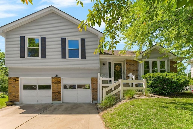 15905 W 152nd Ter, Olathe, KS 66062 - split level home with brick siding, an attached garage, concrete driveway, and a front yard