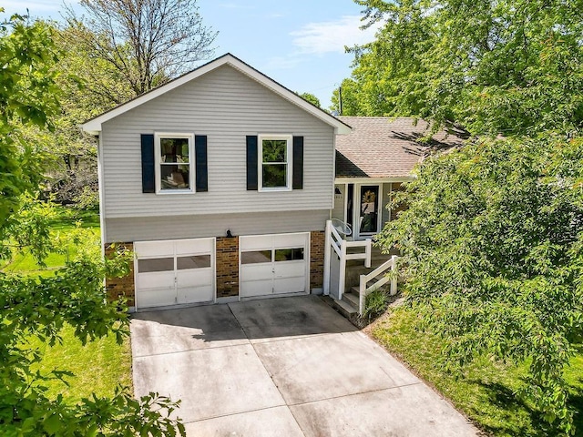 15905 W 152nd Ter, Olathe, KS 66062 - split level home with brick siding, concrete driveway, and an attached garage