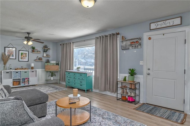 living area with a textured ceiling and wood finished floors