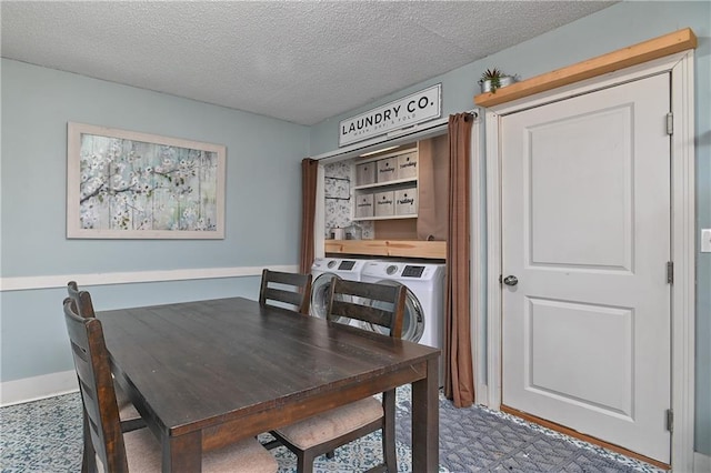 dining room with a textured ceiling, baseboards, and washing machine and clothes dryer