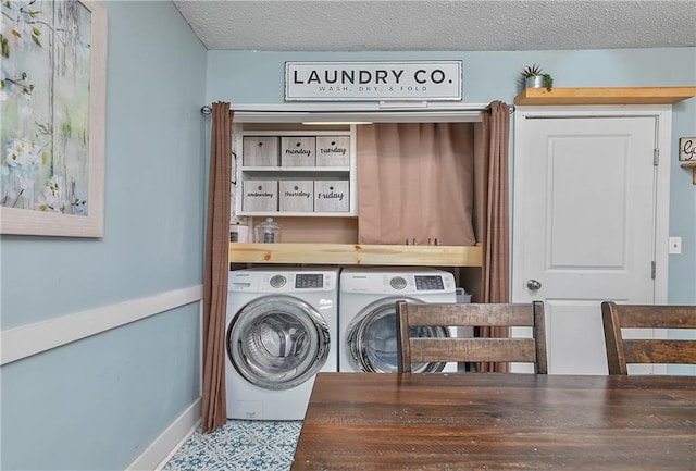 laundry room featuring laundry area, a textured ceiling, and separate washer and dryer