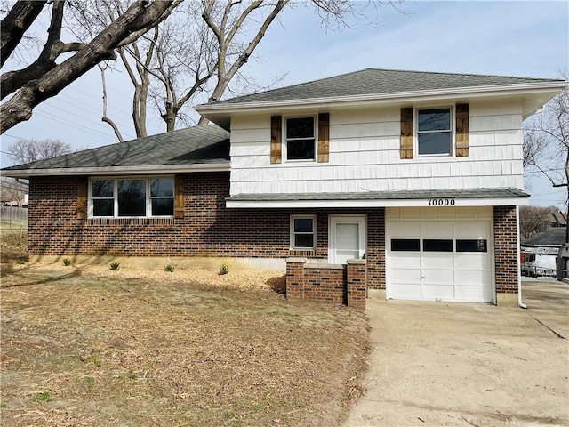 tri-level home with brick siding, an attached garage, concrete driveway, and roof with shingles