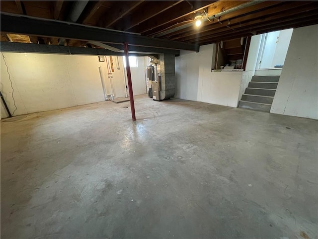 below grade area with heating unit and stairs