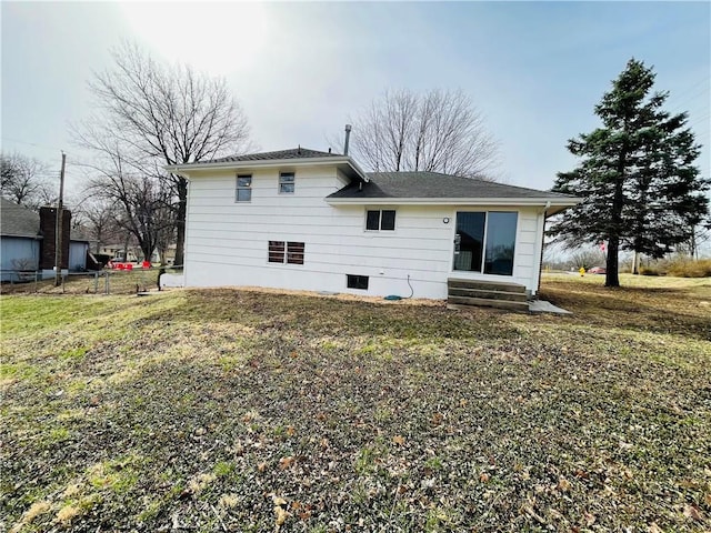 rear view of property with a yard and entry steps