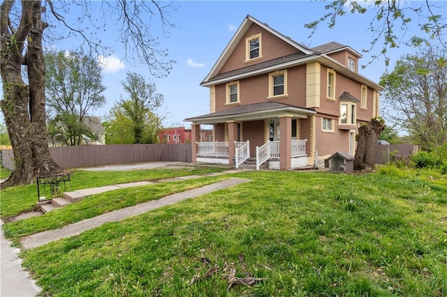 view of front of home with covered porch, a front yard, fence, and stucco siding