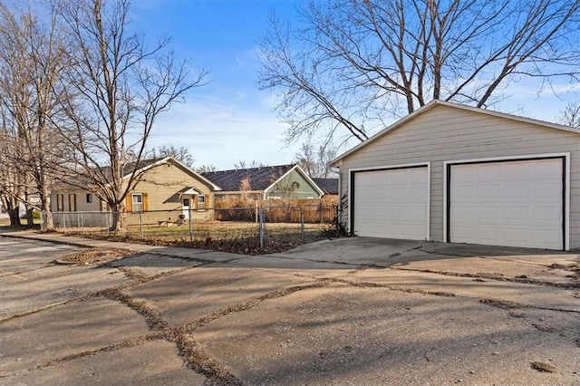 detached garage featuring fence