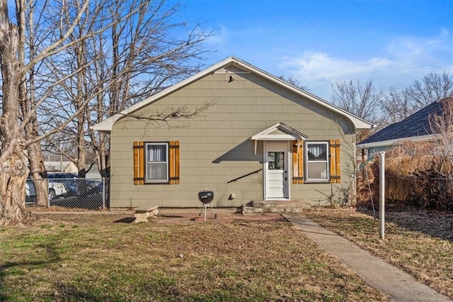 bungalow-style house featuring a front yard and fence