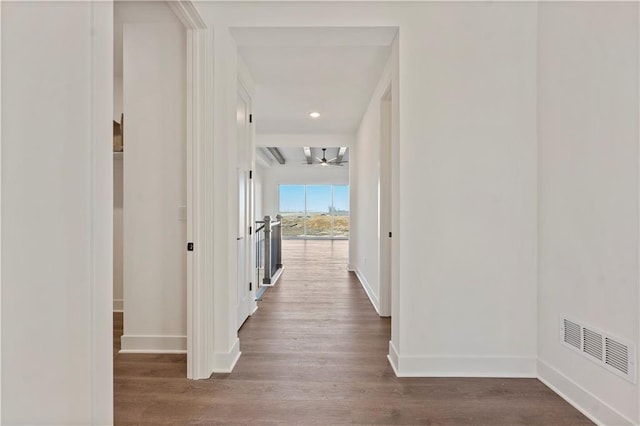 hall with recessed lighting, visible vents, baseboards, and wood finished floors