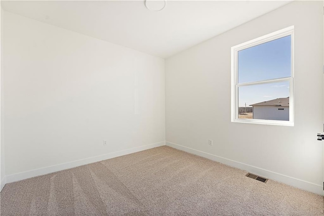 carpeted empty room with baseboards and visible vents