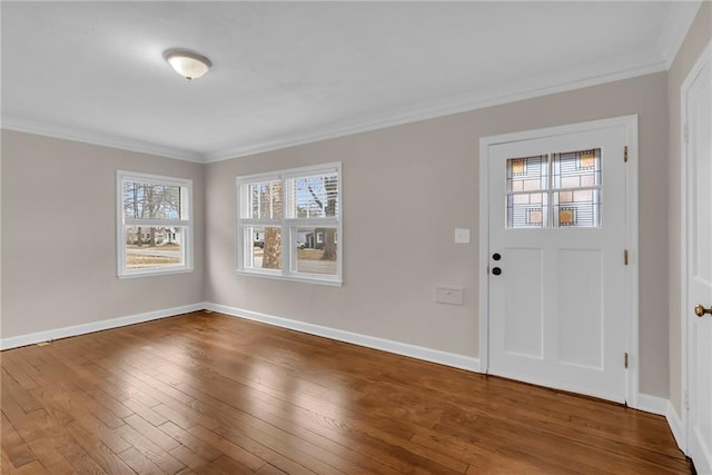 entryway with ornamental molding, plenty of natural light, baseboards, and hardwood / wood-style flooring