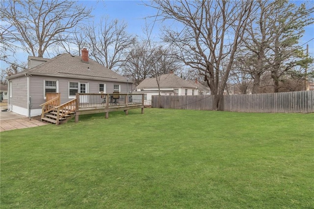 view of yard with a fenced backyard, a patio, and a wooden deck