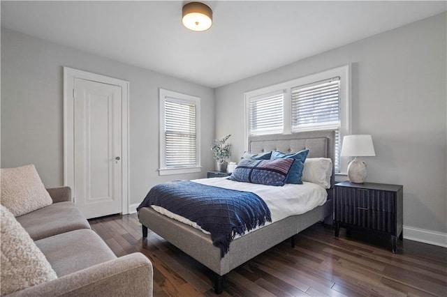 bedroom with hardwood / wood-style floors and baseboards