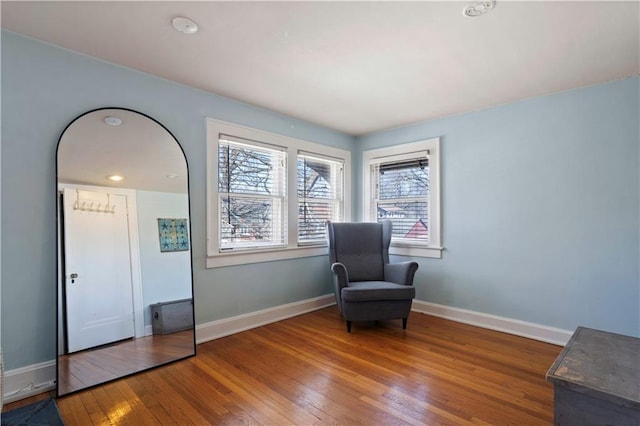 sitting room featuring baseboards and wood-type flooring