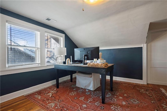 office space featuring visible vents, baseboards, wood finished floors, and vaulted ceiling