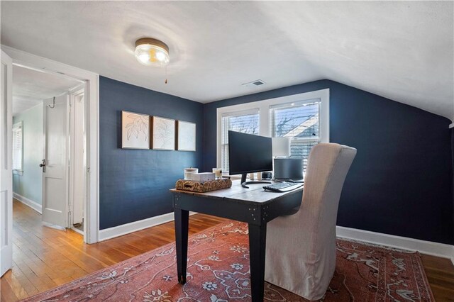 office with visible vents, baseboards, and wood finished floors