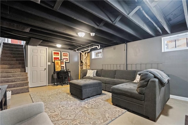 living room with concrete flooring and stairs