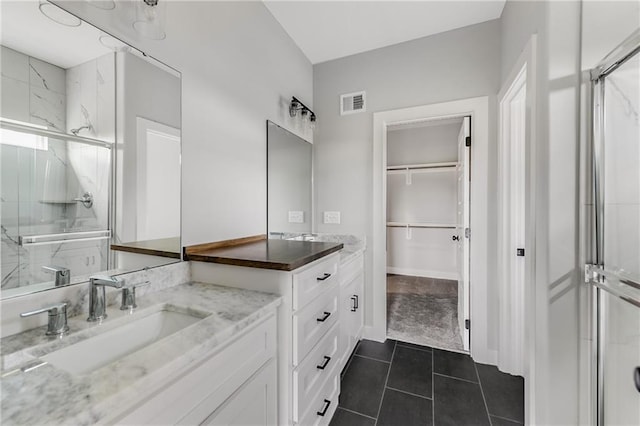 full bath with visible vents, tile patterned floors, a spacious closet, vanity, and a shower stall