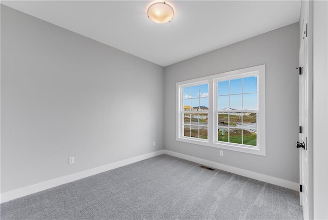 carpeted empty room with baseboards