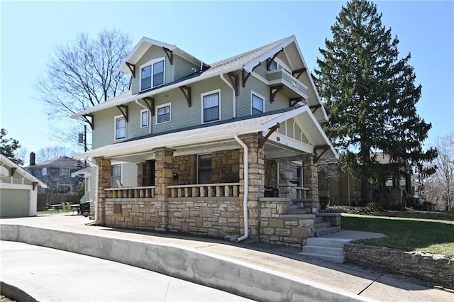 view of front of property with stone siding and a porch