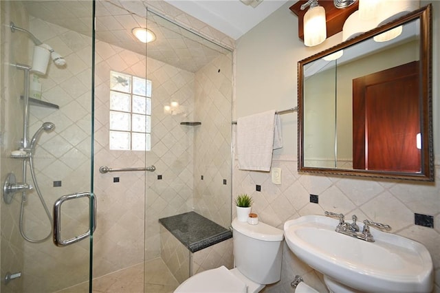 bathroom with a shower stall, toilet, tile walls, and a sink