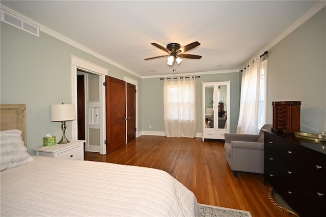 bedroom featuring visible vents, ornamental molding, baseboards, ceiling fan, and dark wood-style flooring