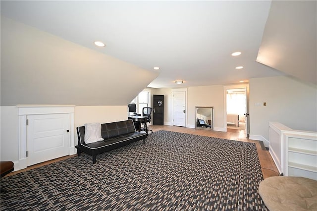 interior space featuring vaulted ceiling, recessed lighting, baseboards, and wood finished floors