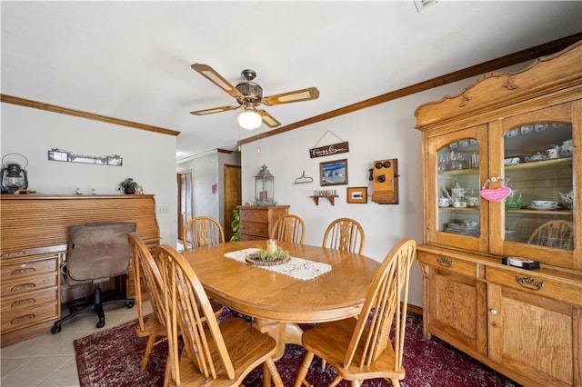 dining area with light tile patterned floors, ornamental molding, and a ceiling fan