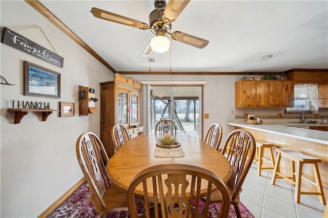 dining area with a ceiling fan, visible vents, crown molding, and light tile patterned floors