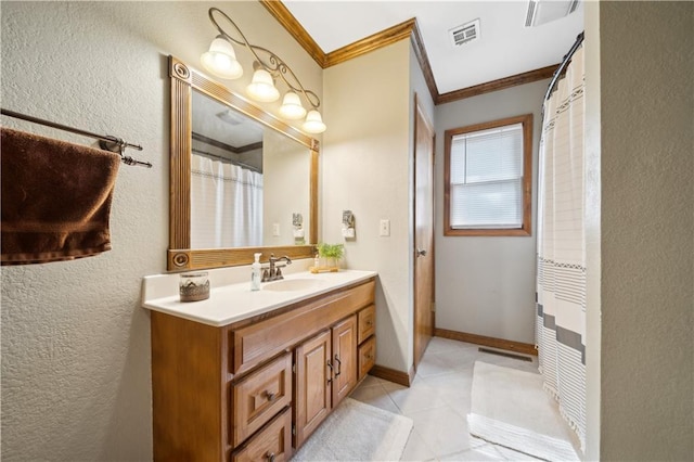 bathroom featuring vanity, baseboards, visible vents, tile patterned floors, and crown molding