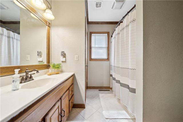 bathroom with tile patterned flooring, visible vents, vanity, and baseboards