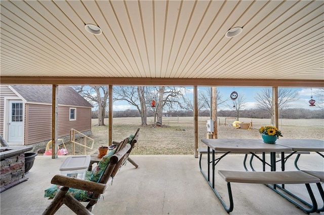 view of patio / terrace featuring outdoor dining space and an outdoor structure