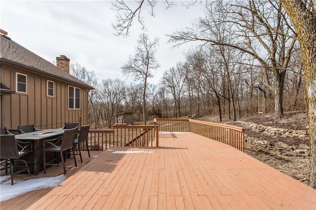 wooden terrace featuring outdoor dining area