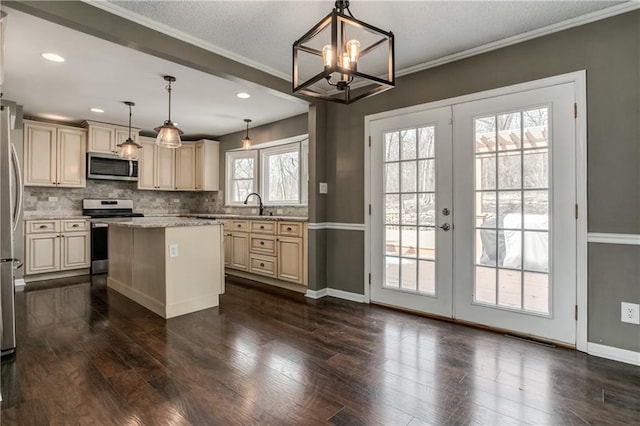 kitchen featuring appliances with stainless steel finishes, cream cabinetry, and french doors