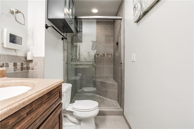 full bath featuring toilet, recessed lighting, vanity, a shower stall, and tile patterned floors