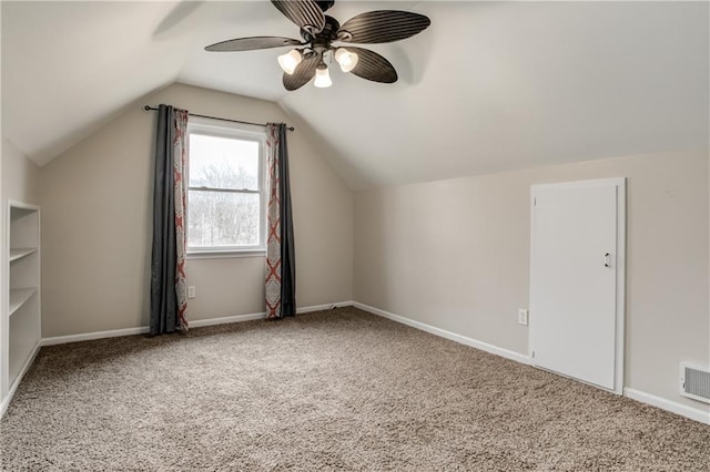 bonus room featuring lofted ceiling, ceiling fan, carpet, and baseboards