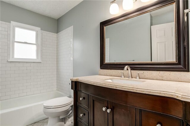 full bath featuring toilet,  shower combination, a textured ceiling, and vanity