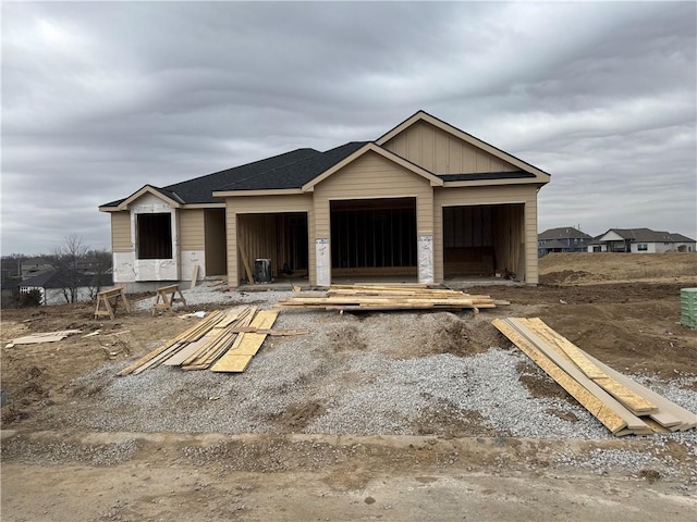 property in mid-construction with a garage, an outdoor structure, and board and batten siding