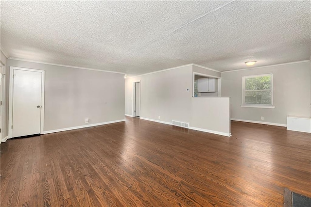 unfurnished living room with crown molding, wood finished floors, visible vents, and baseboards