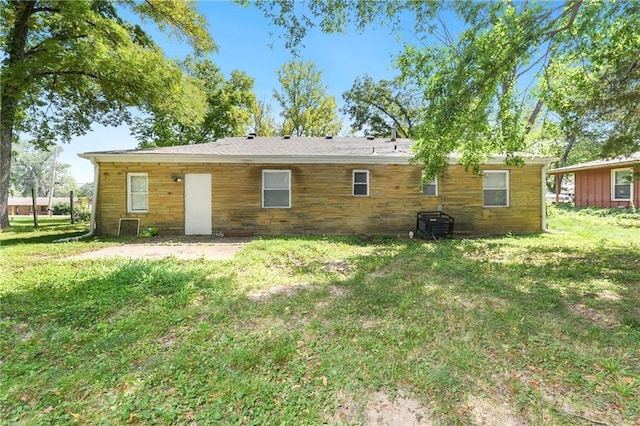 back of house with a lawn