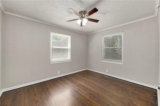 spare room with baseboards, a ceiling fan, wood finished floors, and crown molding