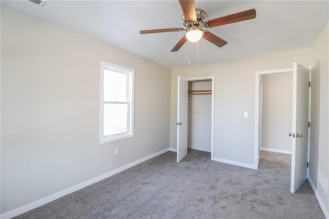 unfurnished bedroom featuring ceiling fan, a closet, carpet flooring, and baseboards