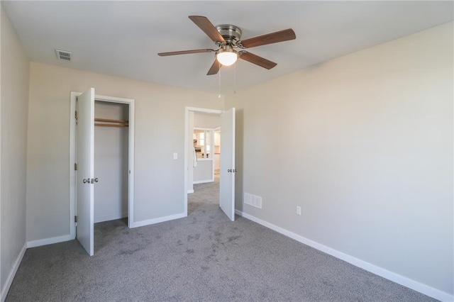 unfurnished bedroom featuring baseboards, visible vents, a closet, and carpet flooring