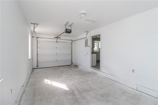 garage with electric panel and a garage door opener